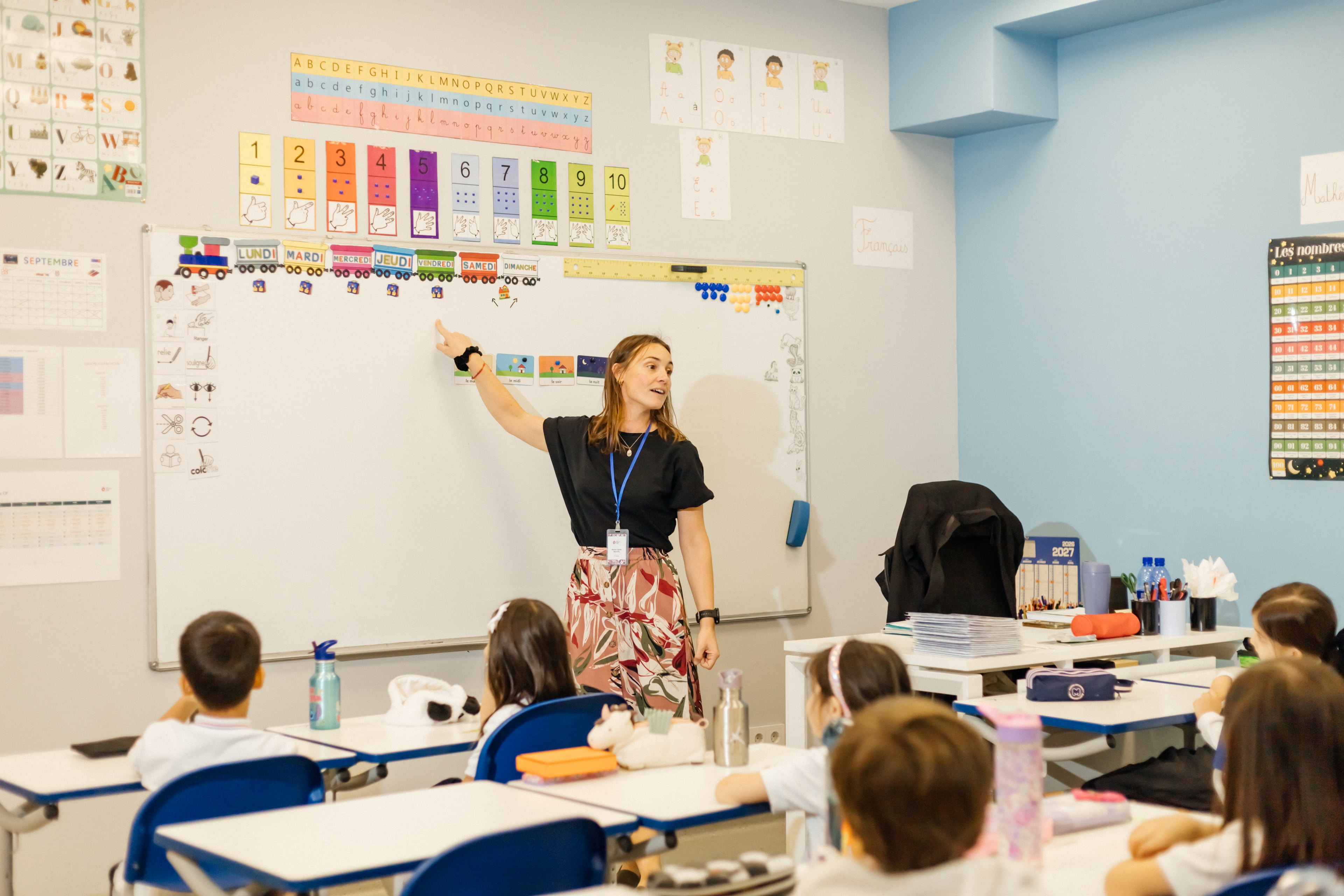 Primary class reading in a bright classroom